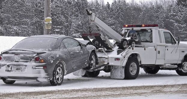 Mitsubishi Mirage being towed by 24-hour tow service in the Lehigh Valley snow